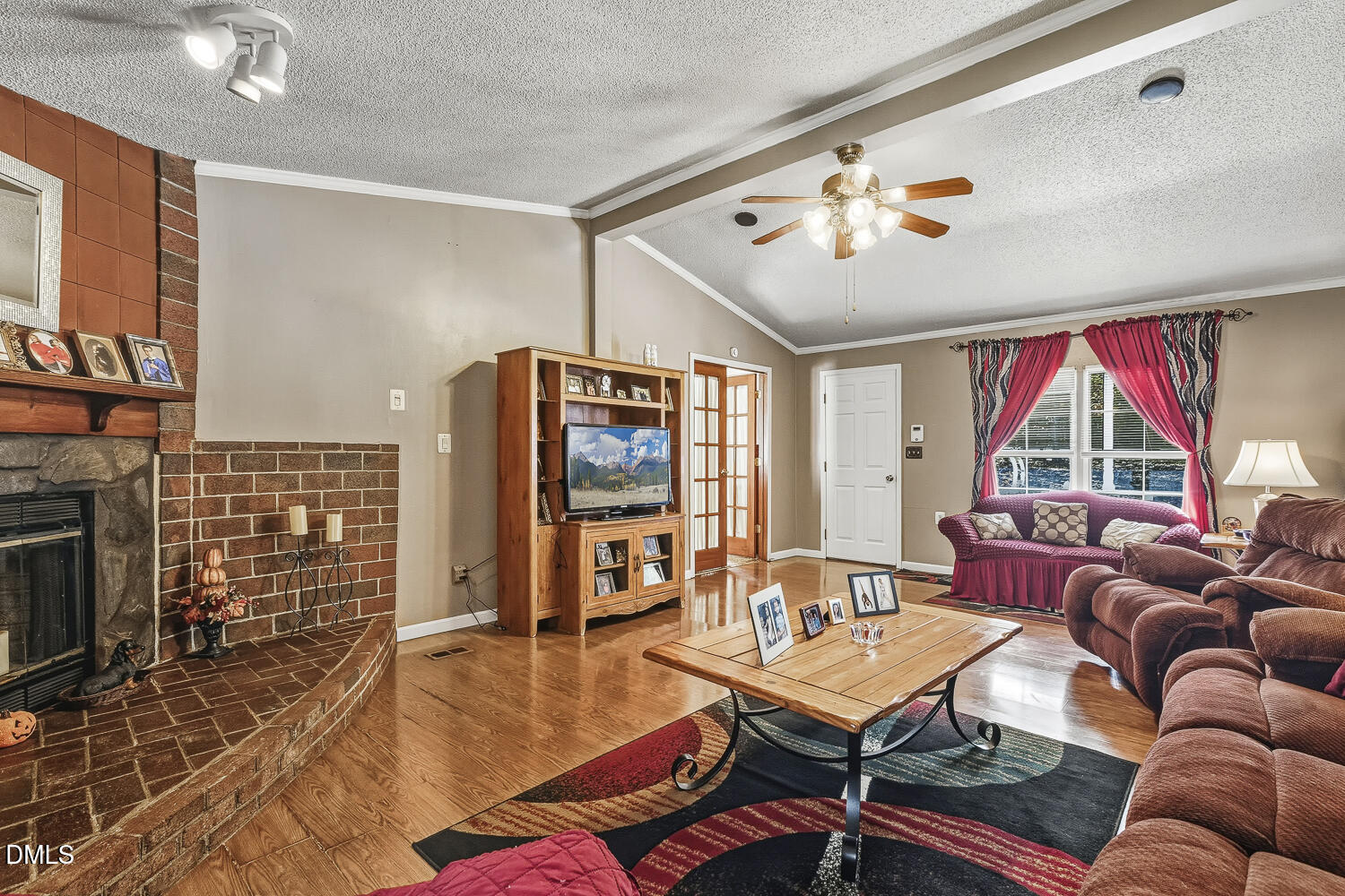 3663 Chewning Road Oxford, NC 27565 - Photo 7 of 43 a living room with furniture a flat screen tv and a fireplace