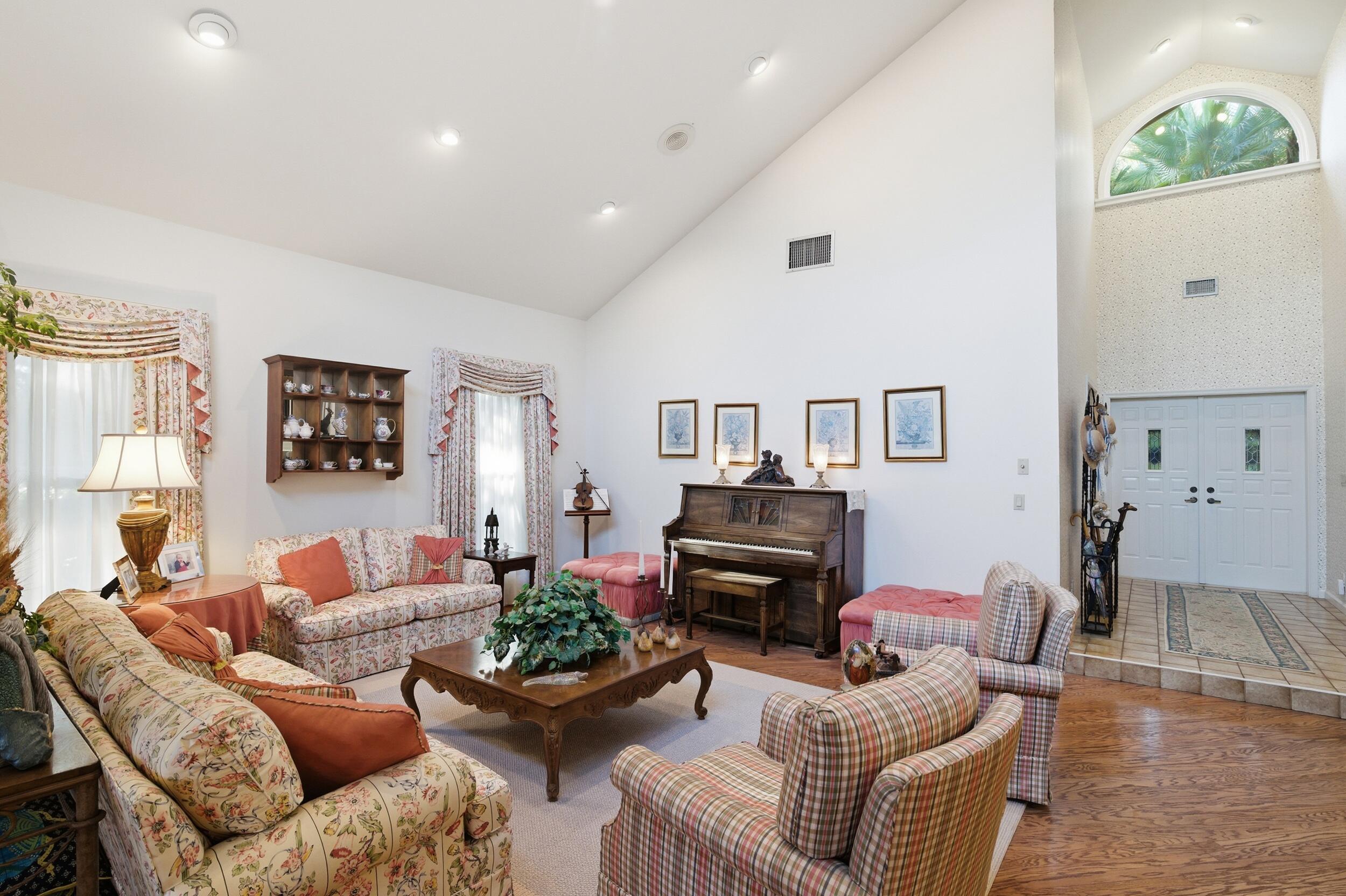 4838 Charlton Way Delray Beach, FL 33484 - Photo 17 of 74 a living room with furniture fireplace and a potted plant