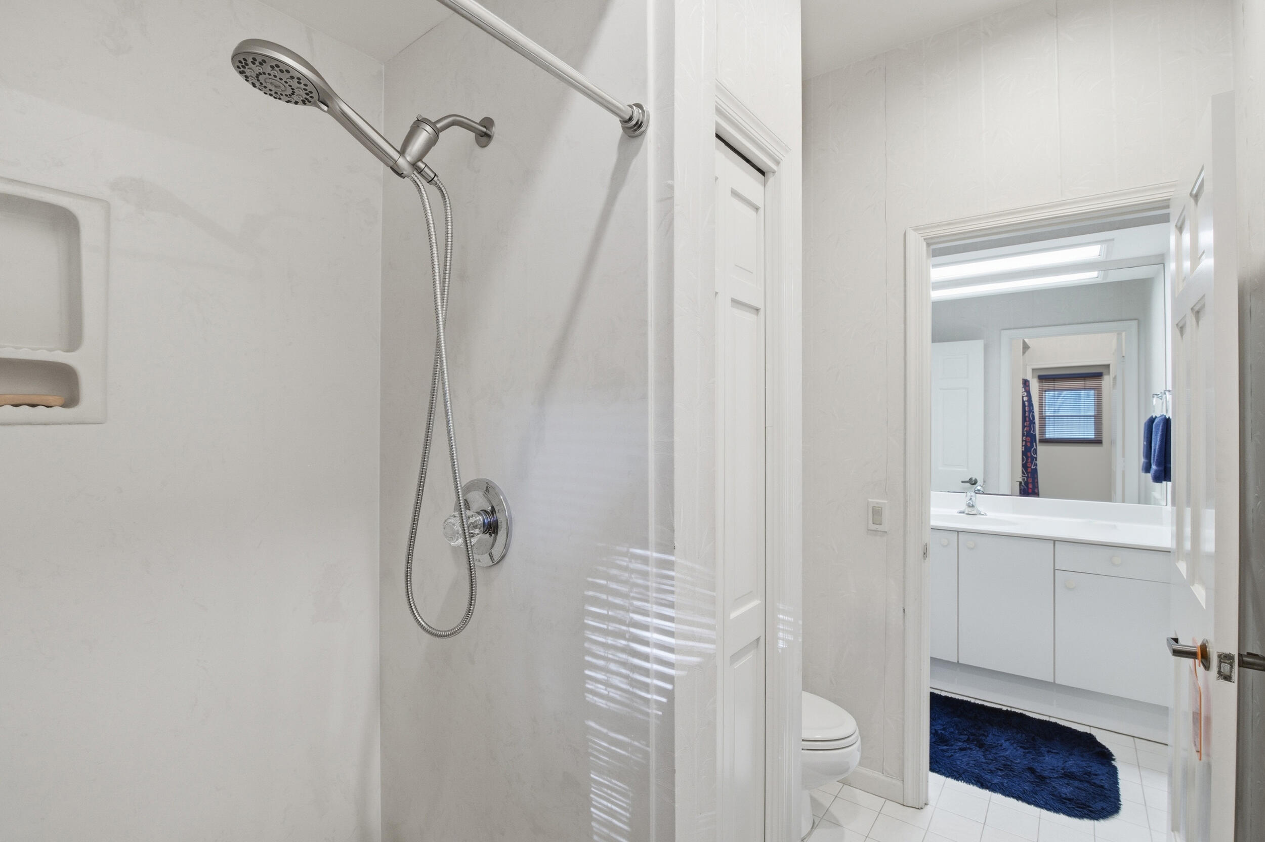 4838 Charlton Way Delray Beach, FL 33484 - Photo 36 of 74 a bathroom with a shower a sink and a mirror