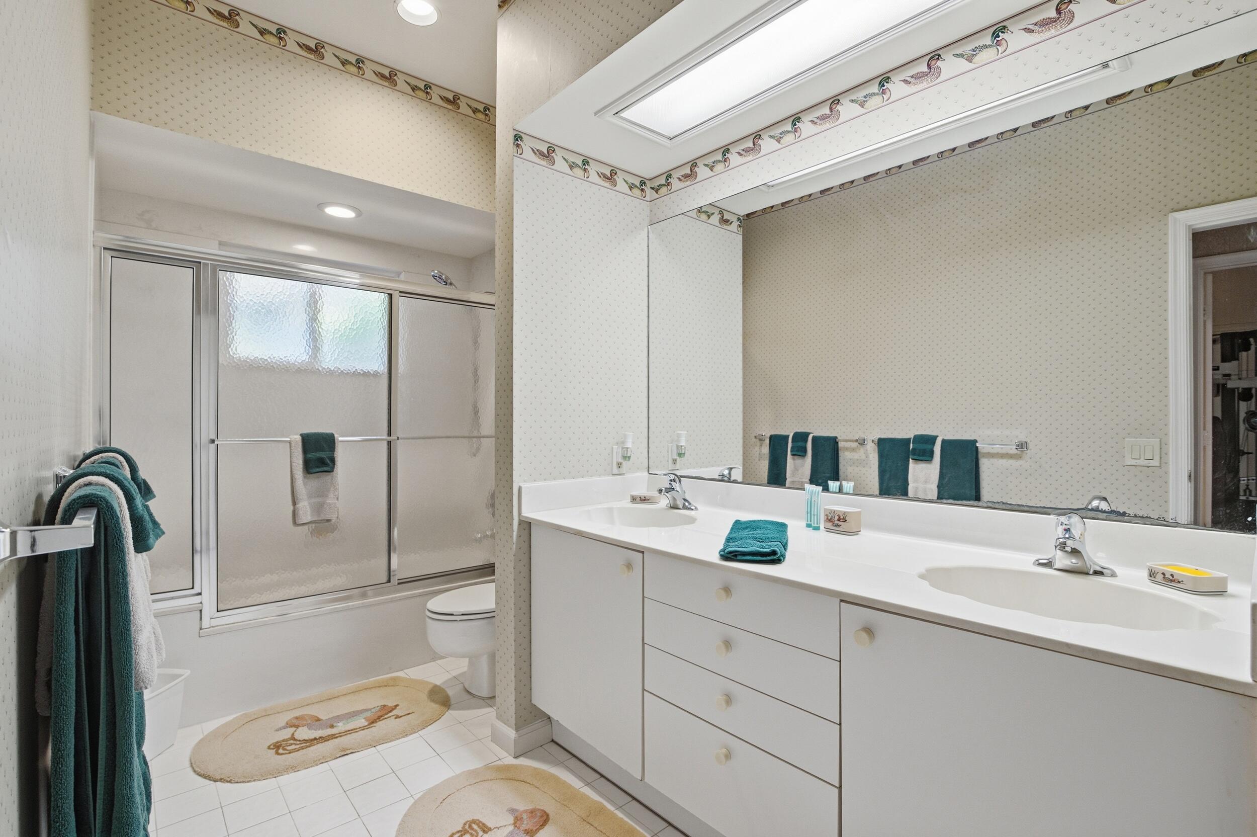 4838 Charlton Way Delray Beach, FL 33484 - Photo 38 of 74 a bathroom with a sink a toilet and shower
