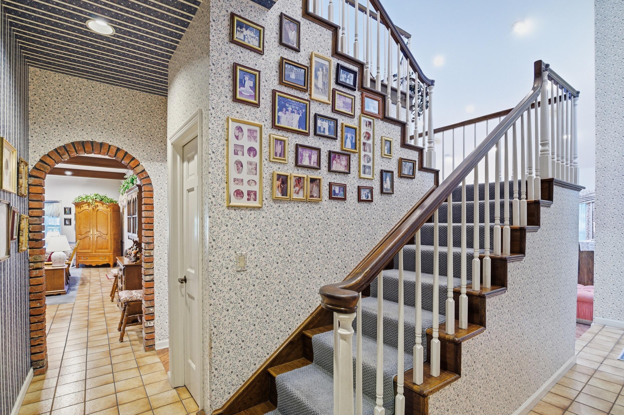4838 Charlton Way Delray Beach, FL 33484 - Photo 39 of 74 a view of staircase with lots of frames on wall and a large window
