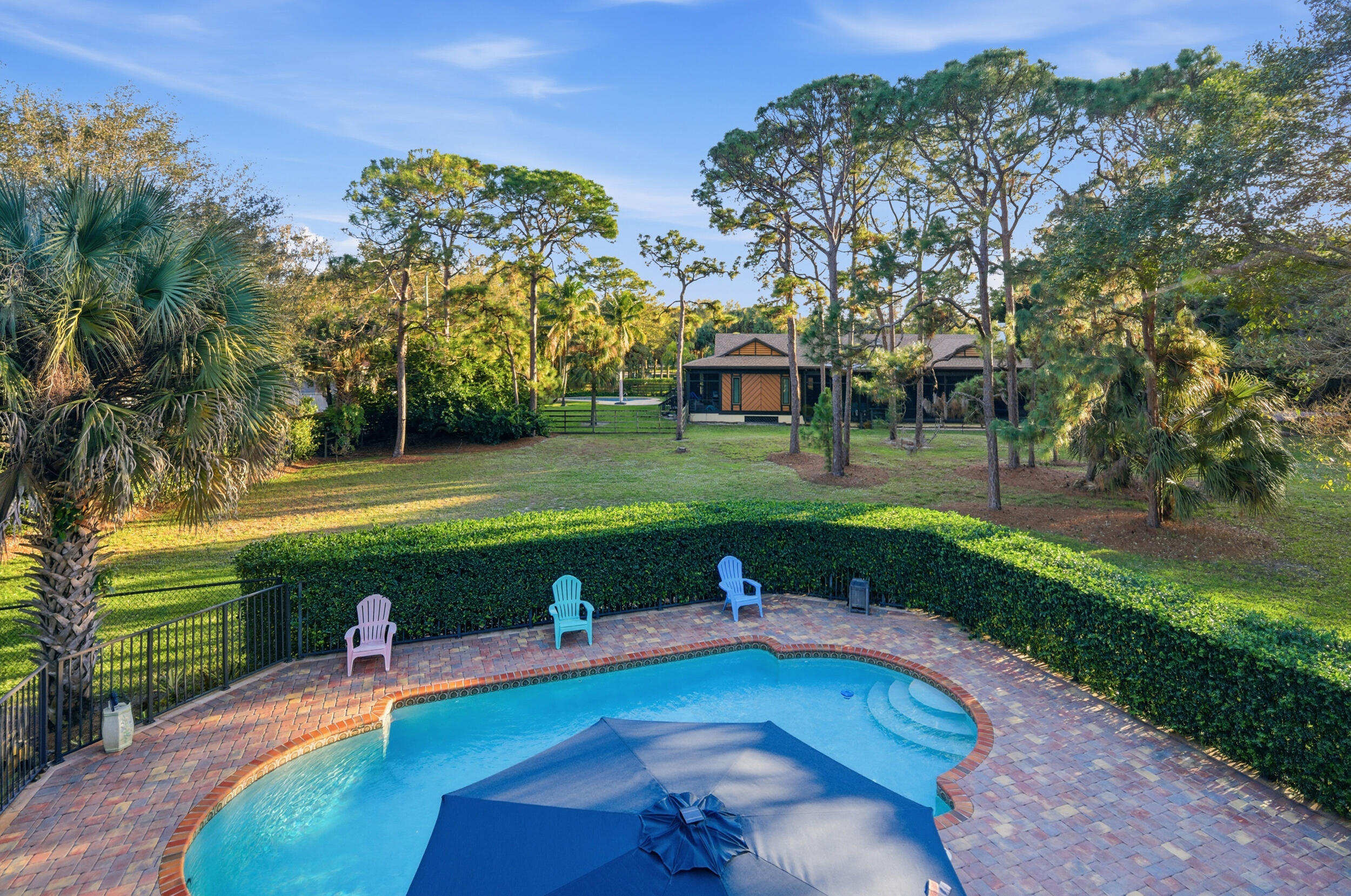 4838 Charlton Way Delray Beach, FL 33484 - Photo 54 of 74 a view of a swimming pool and a yard