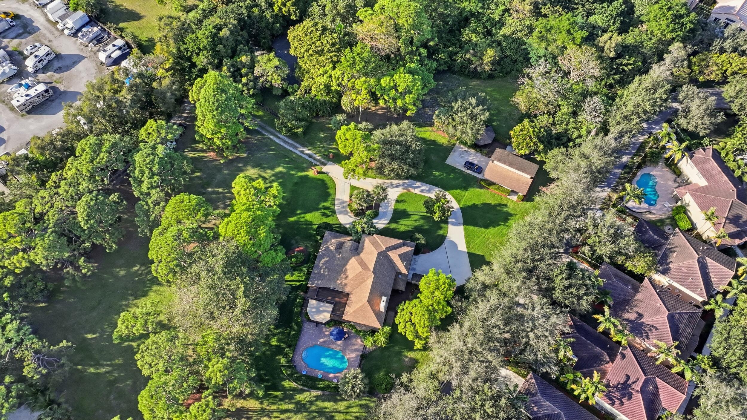 4838 Charlton Way Delray Beach, FL 33484 - Photo 71 of 74 an aerial view of residential house with outdoor space and trees all around