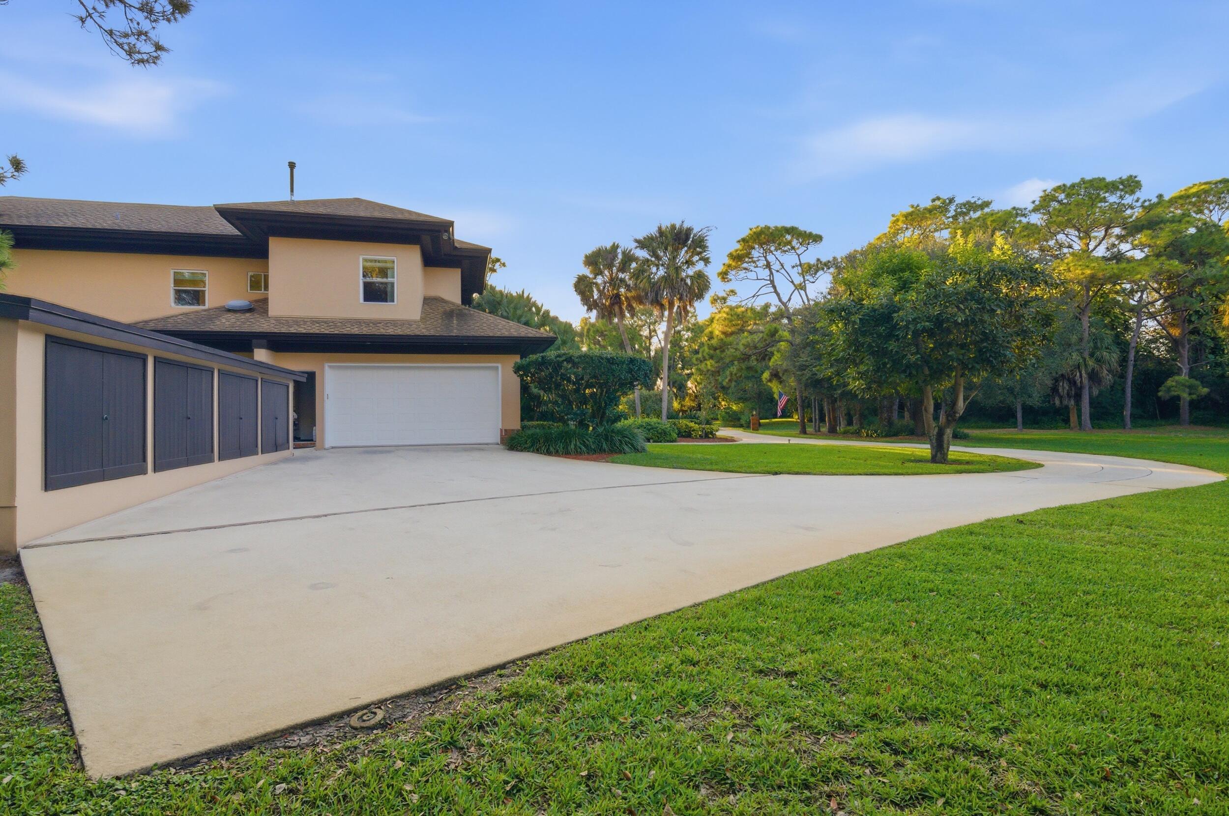 4838 Charlton Way Delray Beach, FL 33484 - Photo 9 of 74 a front view of a house with a yard and garage