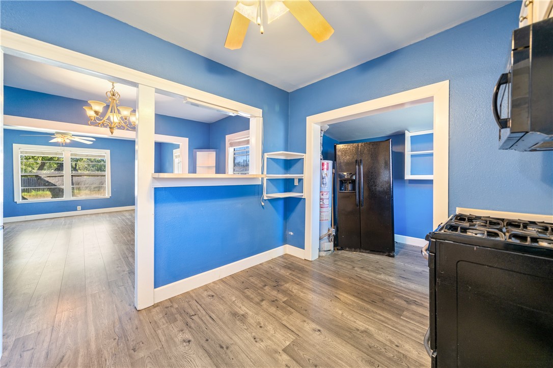 4117 Summit Drive Corpus Christi, TX 78418 - Photo 11 of 22 a view of a livingroom with wooden floor and a kitchen