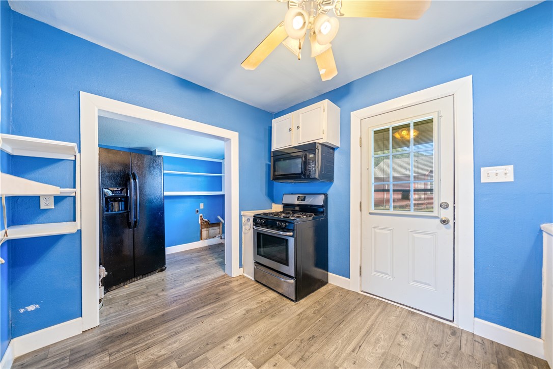 4117 Summit Drive Corpus Christi, TX 78418 - Photo 9 of 22 a view of a kitchen with a stove cabinets and wooden floor