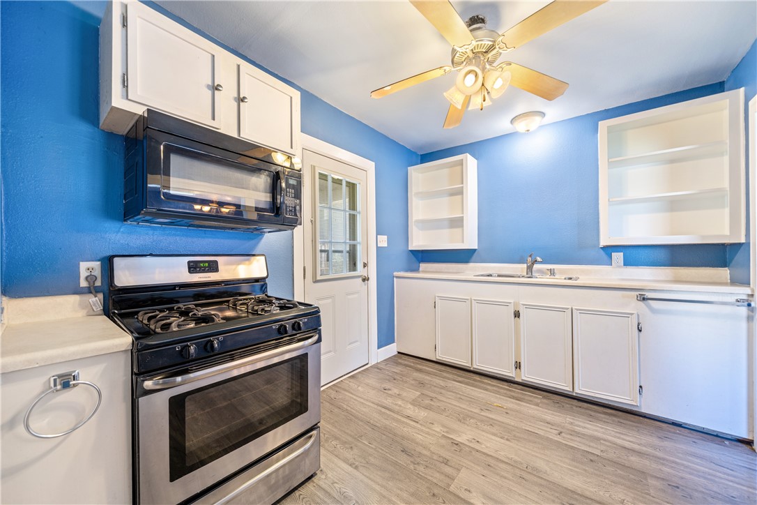 4117 Summit Drive Corpus Christi, TX 78418 - Photo 10 of 22 a kitchen with cabinets stainless steel appliances and wooden floor