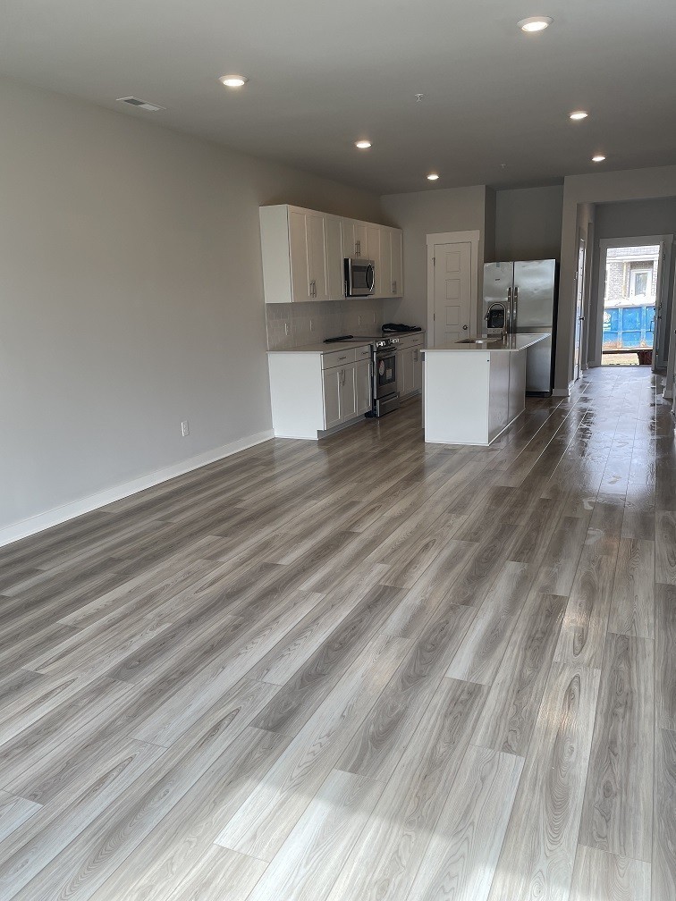 385 Casper Drive Spring Hill, TN 37174 - Photo 5 of 23 a view of kitchen with kitchen island wooden floor center island and stainless steel appliances refrigerator