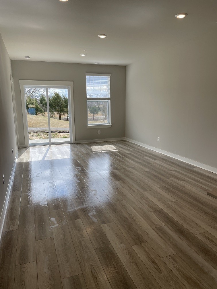 385 Casper Drive Spring Hill, TN 37174 - Photo 6 of 23 wooden floor in an empty room with a window