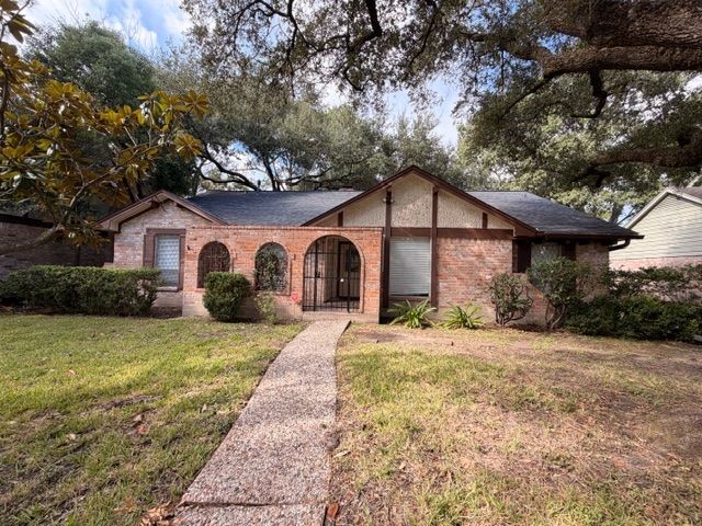 2807 Kenross Street Houston, TX 77043 - Photo 1 of 21 a view of a yard in front of a house with a large tree