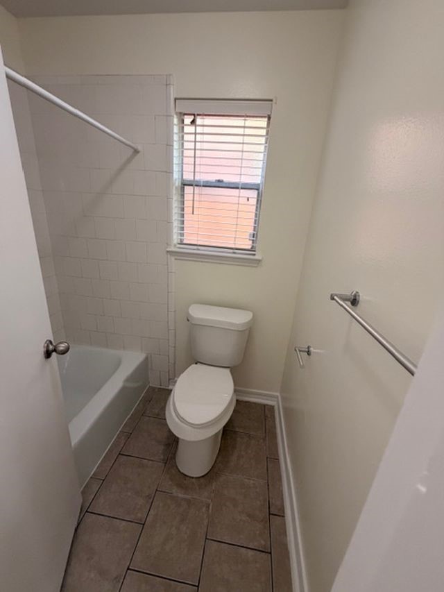 2807 Kenross Street Houston, TX 77043 - Photo 12 of 21 a bathroom with a granite countertop toilet a sink and a bathtub