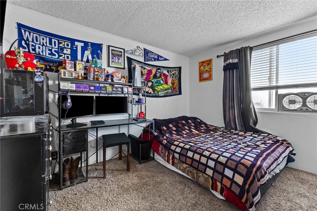 33945 Red Mountain Road Hemet, CA 92544 - Photo 14 of 30 a bedroom with a bed and a flat screen tv