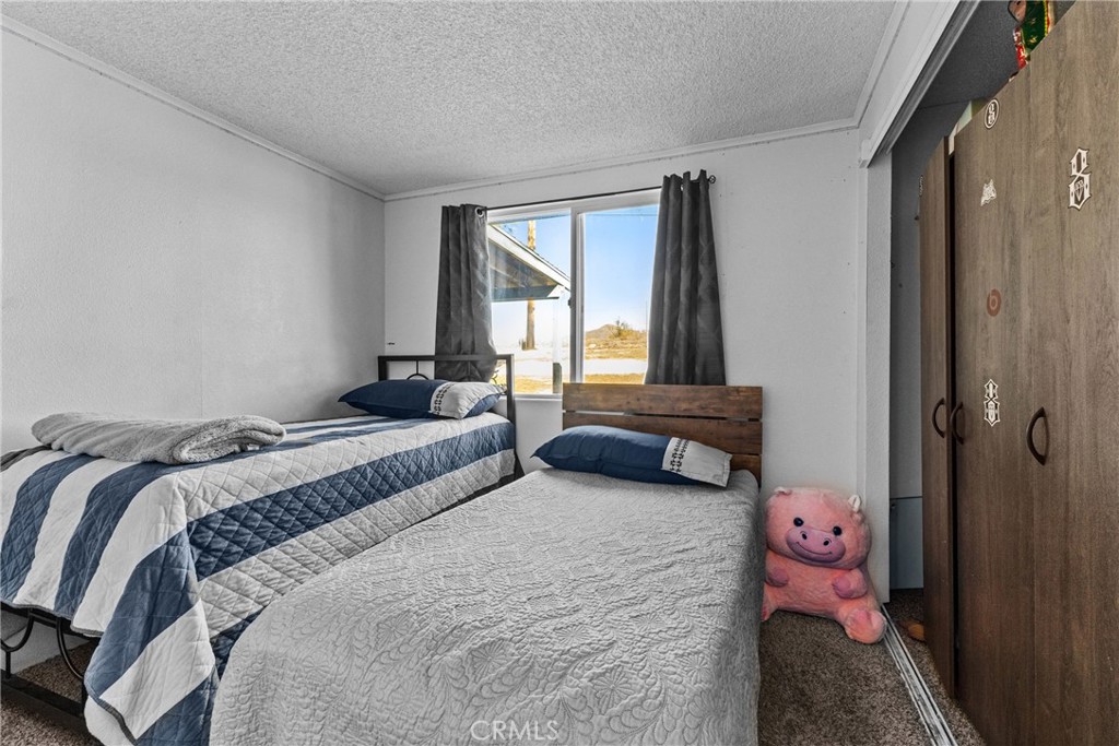 33945 Red Mountain Road Hemet, CA 92544 - Photo 15 of 30 a bedroom with a bed and a window