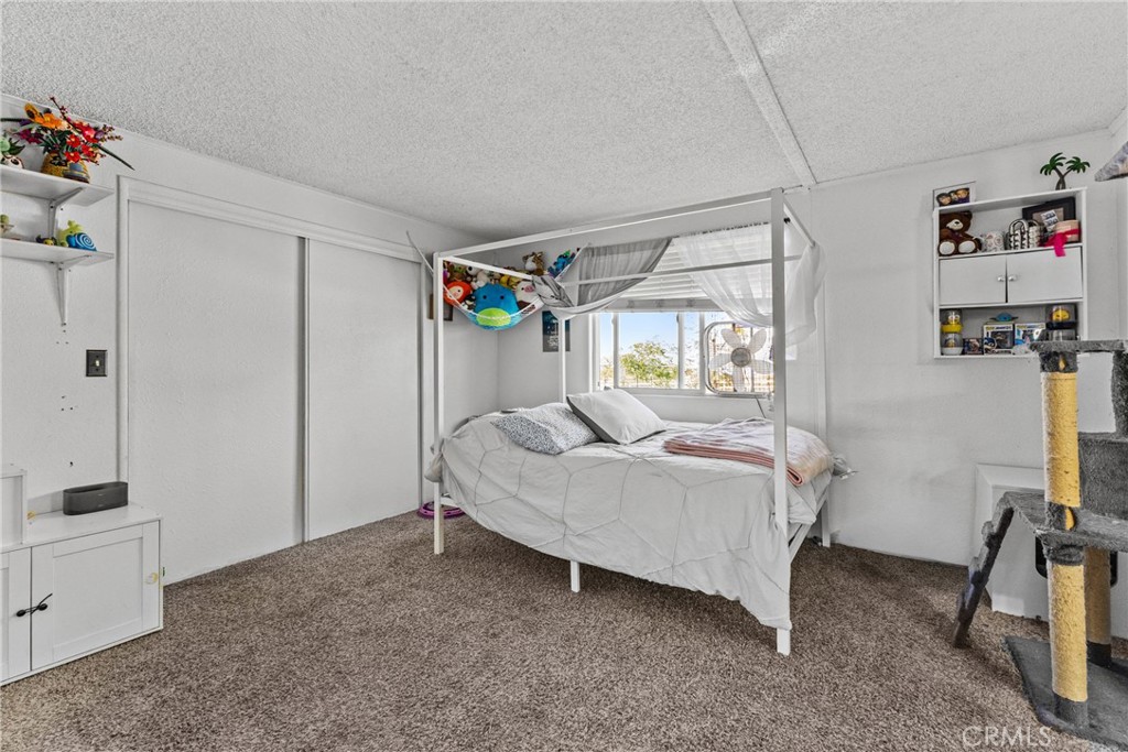 33945 Red Mountain Road Hemet, CA 92544 - Photo 19 of 30 a bed room with a bed and a window