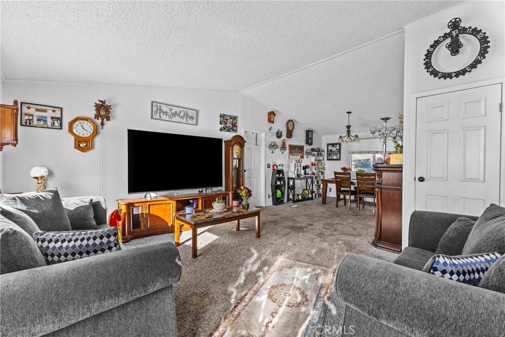 33945 Red Mountain Road Hemet, CA 92544 - Photo 9 of 30 a living room with furniture and a flat screen tv