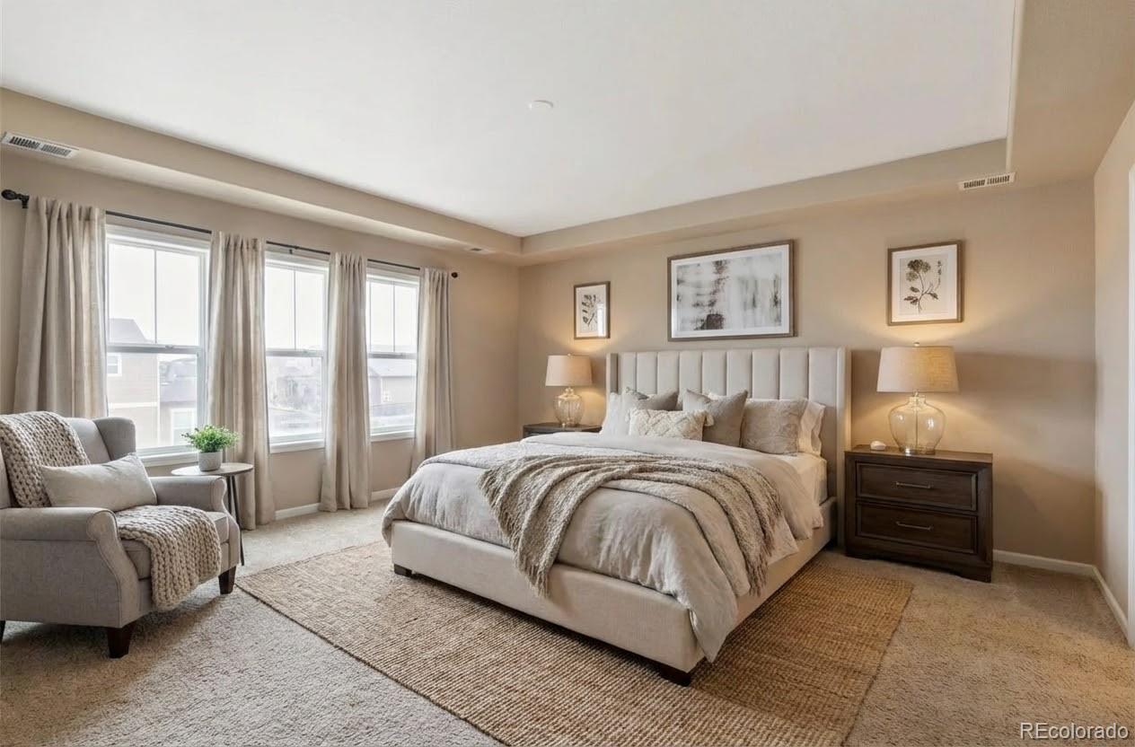 10995 Quintero Street Commerce City, CO 80022 - Photo 20 of 41 a spacious bedroom with a bed and glass window