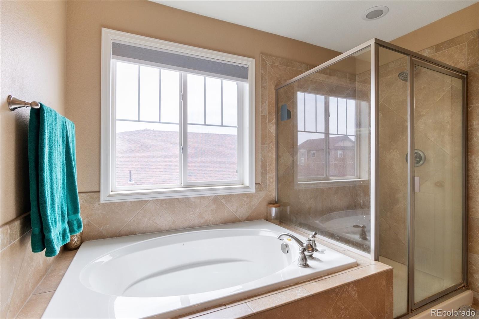 10995 Quintero Street Commerce City, CO 80022 - Photo 22 of 41 a bathroom with a tub and a shower