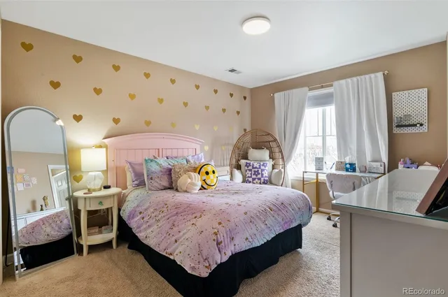 a bedroom with a bed and a table