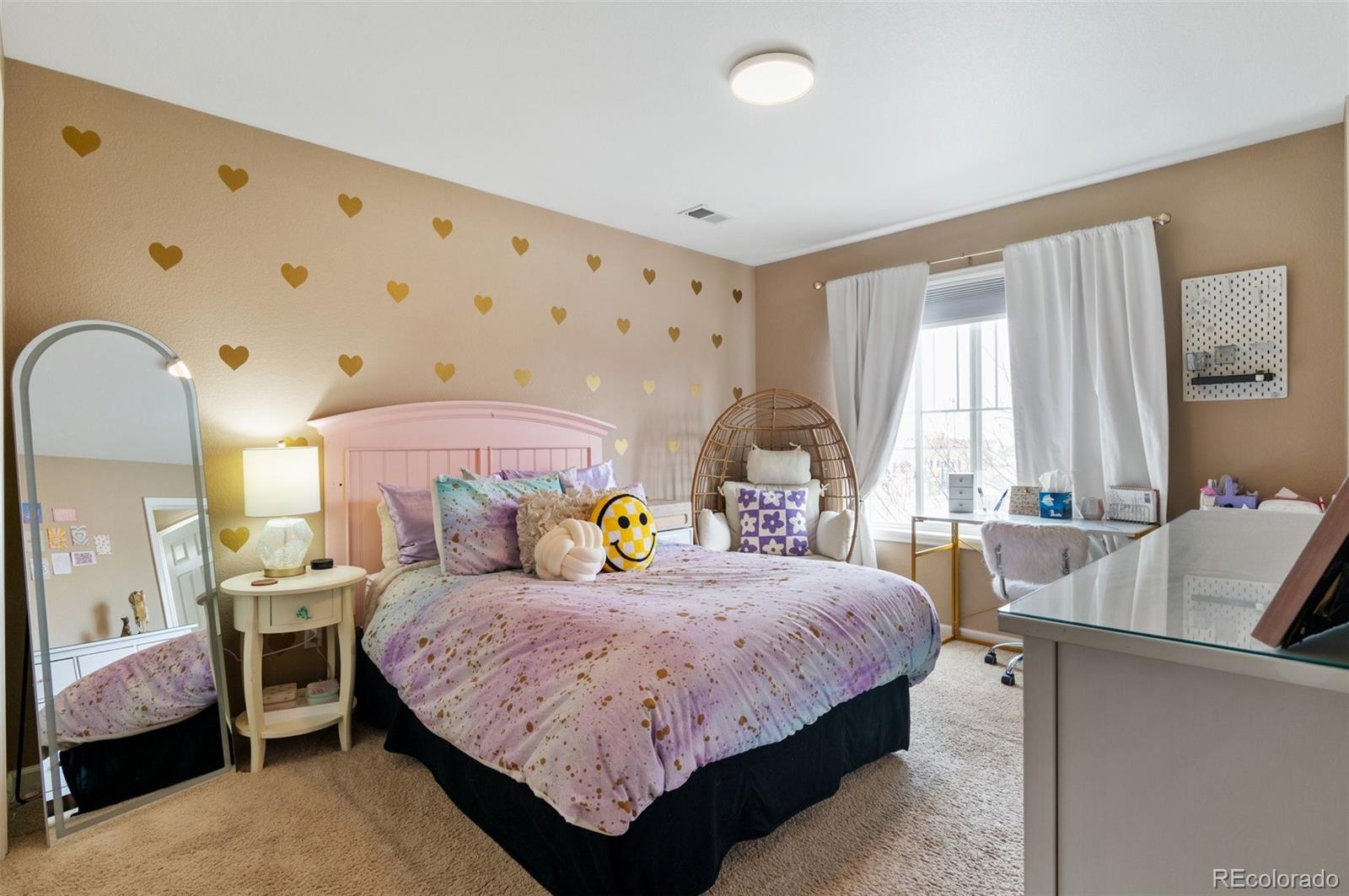 10995 Quintero Street Commerce City, CO 80022 - Photo 23 of 41 a bedroom with a bed and a table