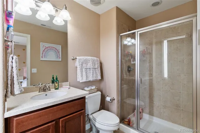 a bathroom with a sink vanity mirror and toilet