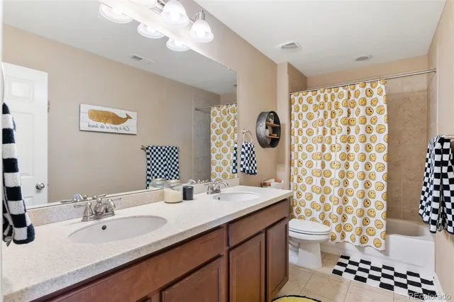 a bathroom with a sink a toilet and a large mirror
