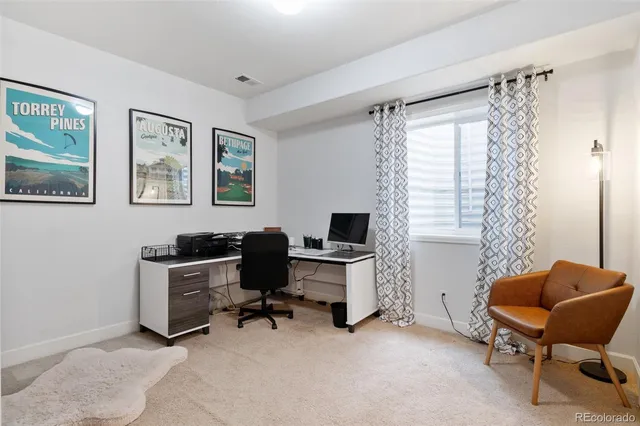 a view of a workspace with lounge chair and a window