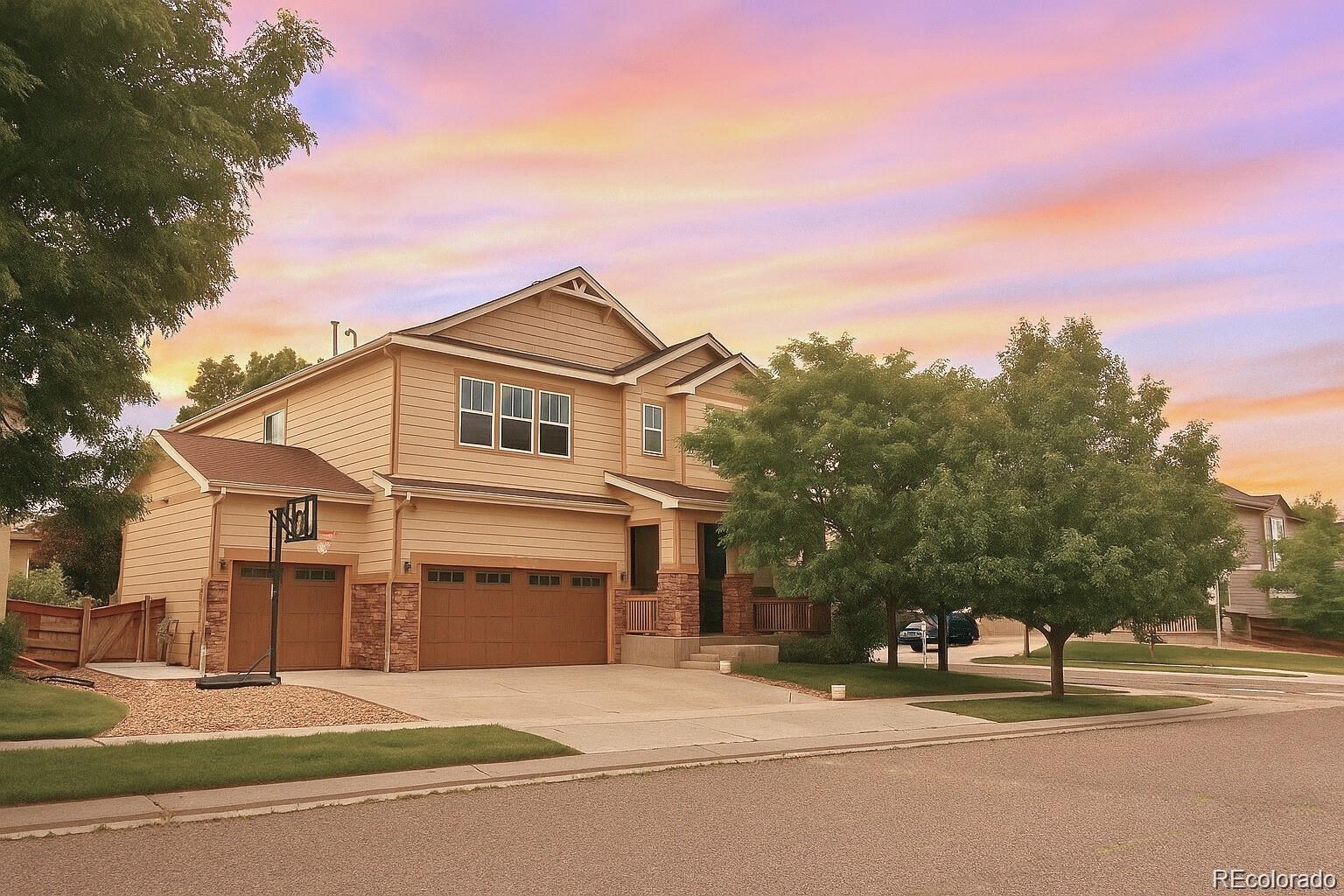 10995 Quintero Street Commerce City, CO 80022 - Photo 39 of 41 a front view of a house with a yard and garage