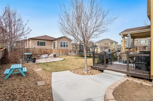 a view of a house with a yard patio and fire pit
