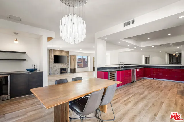 a large kitchen with stainless steel appliances granite countertop a stove and a wooden floors