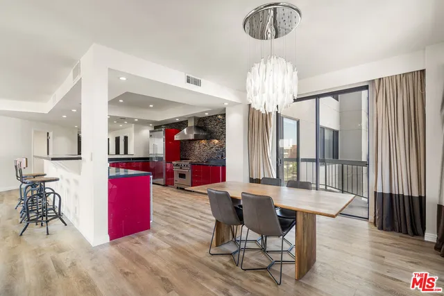 a kitchen with red appliances kitchen island granite countertop a red stove sink and cabinets
