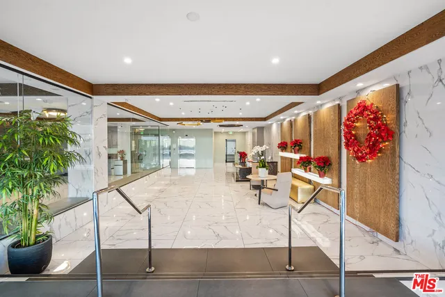 a living room with fireplace furniture and a potted plant