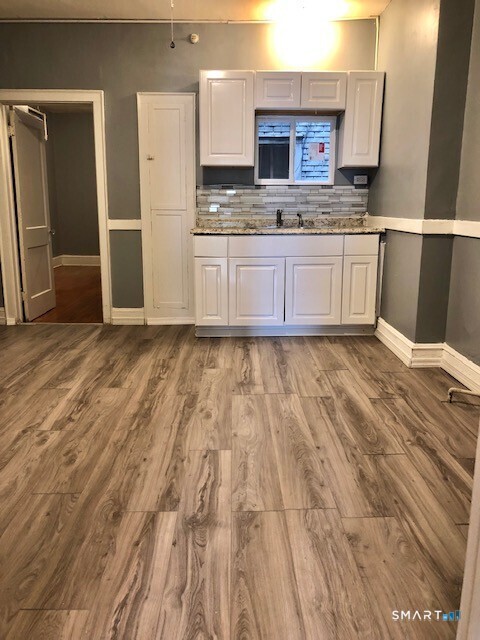 a kitchen with stainless steel appliances granite countertop a sink and cabinets