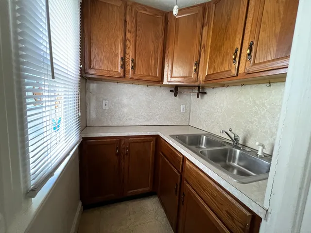 a kitchen with stainless steel appliances granite countertop a sink and cabinets with a sink