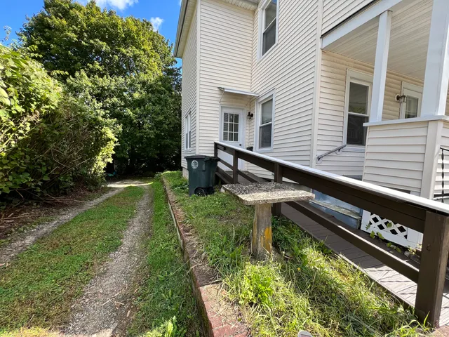 a backyard of a house with outdoor seating