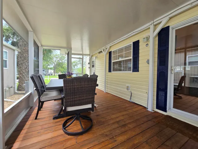 a view of a work space with furniture wooden floor and windows