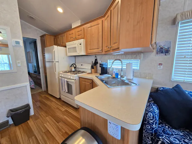 a kitchen with a sink appliances and cabinets