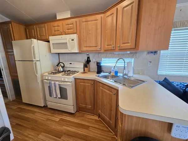 a kitchen with a sink a stove and refrigerator