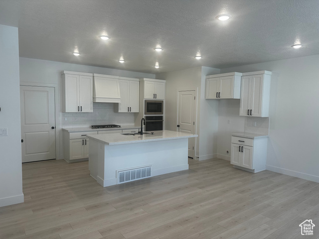 80 South Moonlit Road Mapleton, UT 84664 - Photo 2 of 18 Kitchen featuring backsplash, white cabinetry, custom range hood, a textured ceiling, and recessed lighting