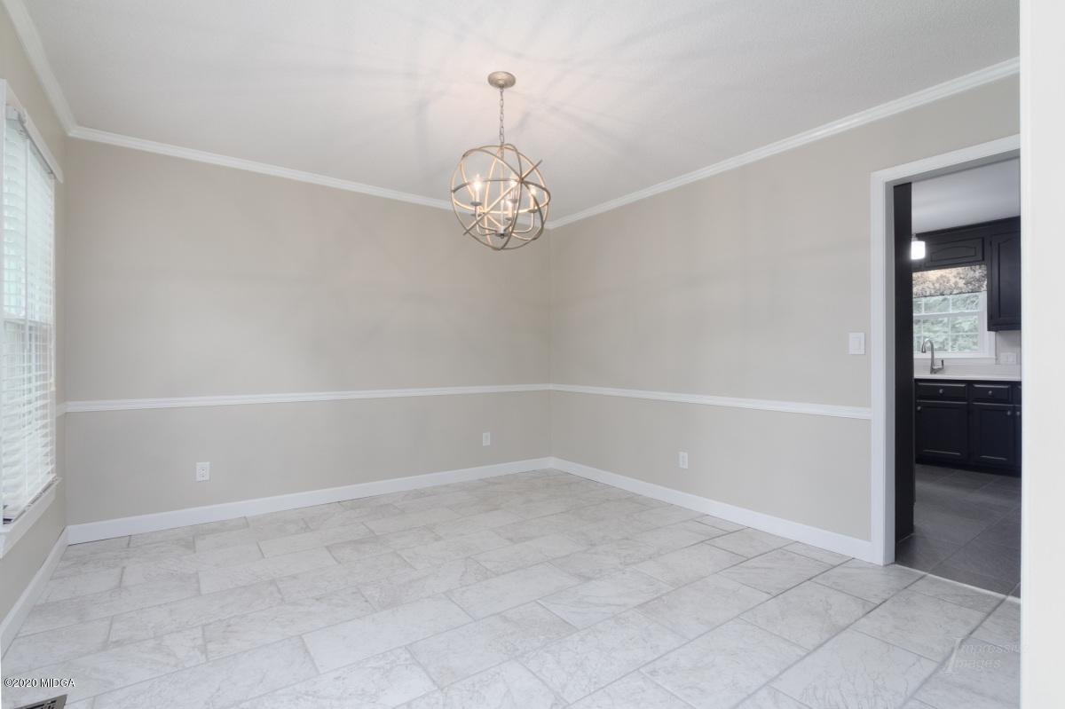 502 Stone Edge Road Macon, GA 31210 - Photo 4 of 22 a view of a room with rack on the wall and a chandelier