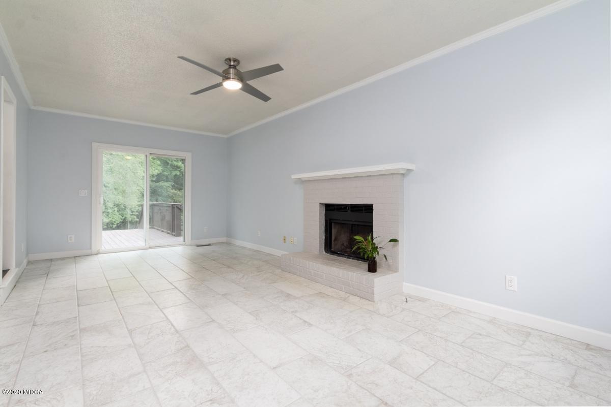 502 Stone Edge Road Macon, GA 31210 - Photo 6 of 22 an empty room with windows and fireplace