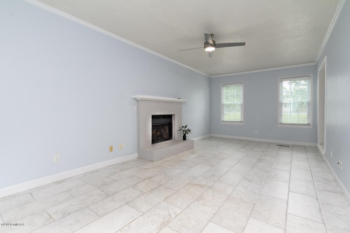 502 Stone Edge Road Macon, GA 31210 - Photo 7 of 22 an empty room with windows and fireplace