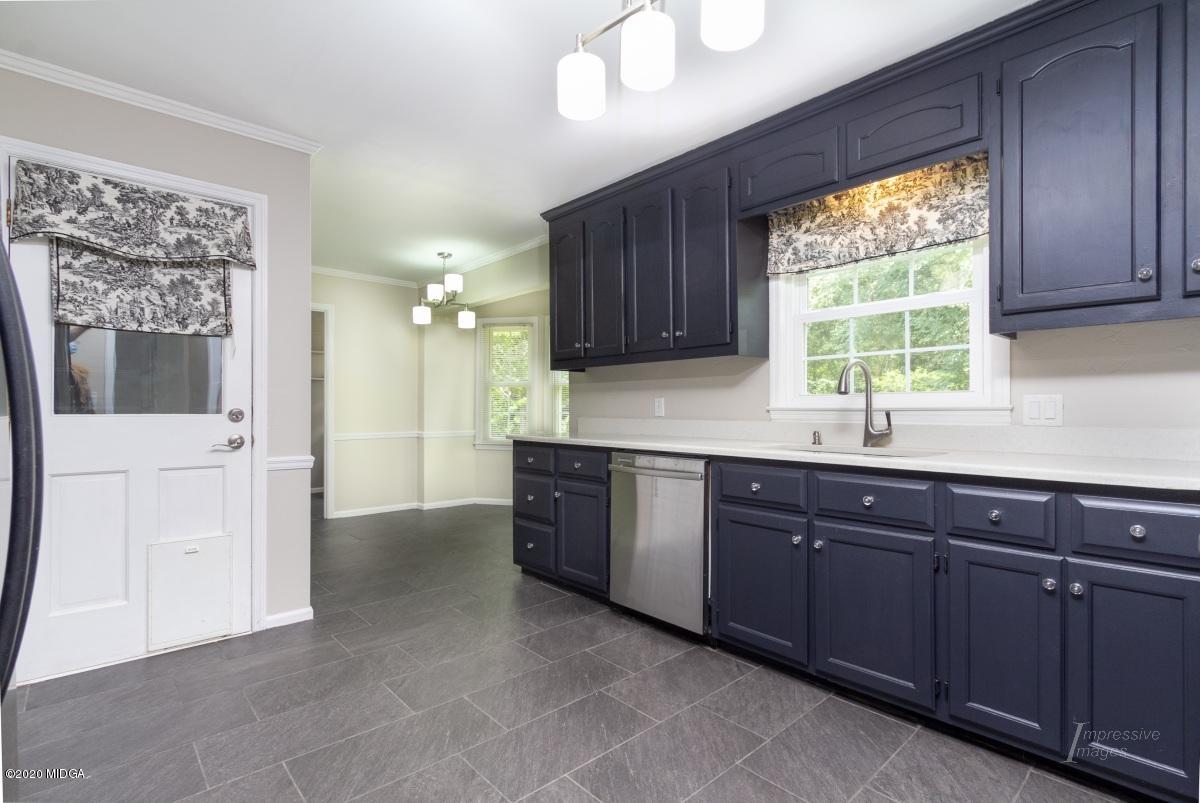 502 Stone Edge Road Macon, GA 31210 - Photo 10 of 22 a kitchen with stainless steel appliances granite countertop wooden cabinets a sink and a window