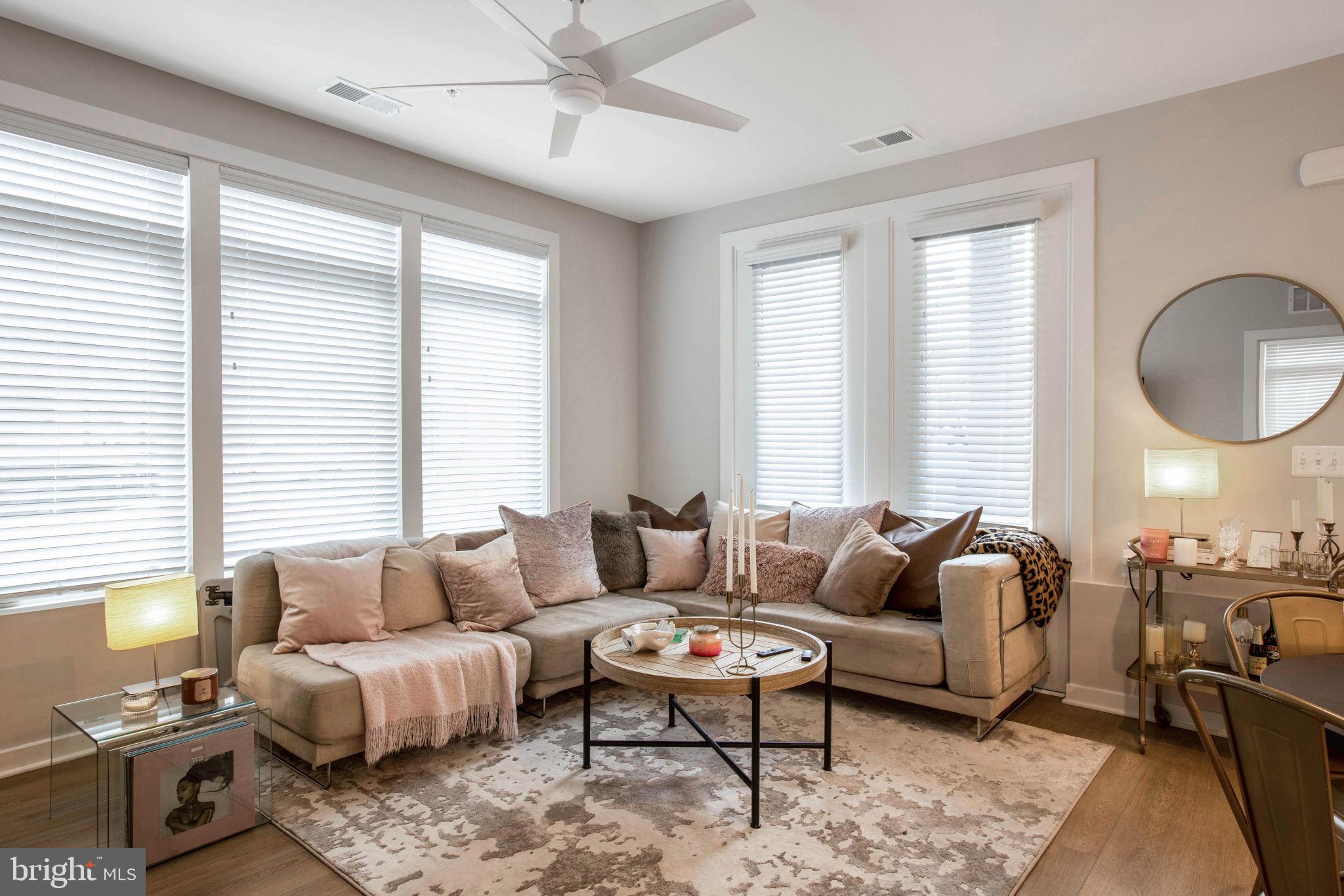1669 Bandit Loop, Unit 107A Reston, VA 20190 - Photo 11 of 30 a living room with furniture a rug and a large window