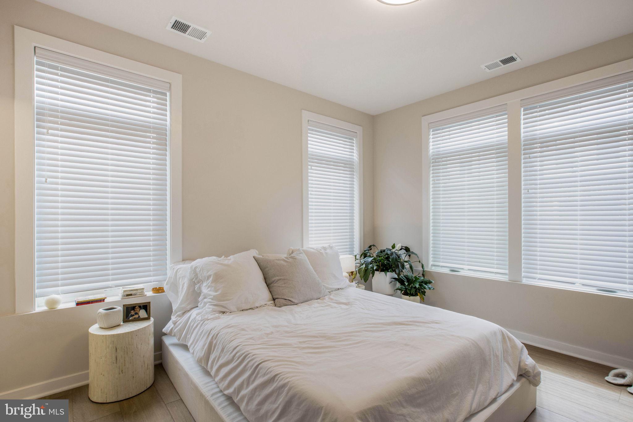 1669 Bandit Loop, Unit 107A Reston, VA 20190 - Photo 14 of 30 a bedroom with a bed and a window
