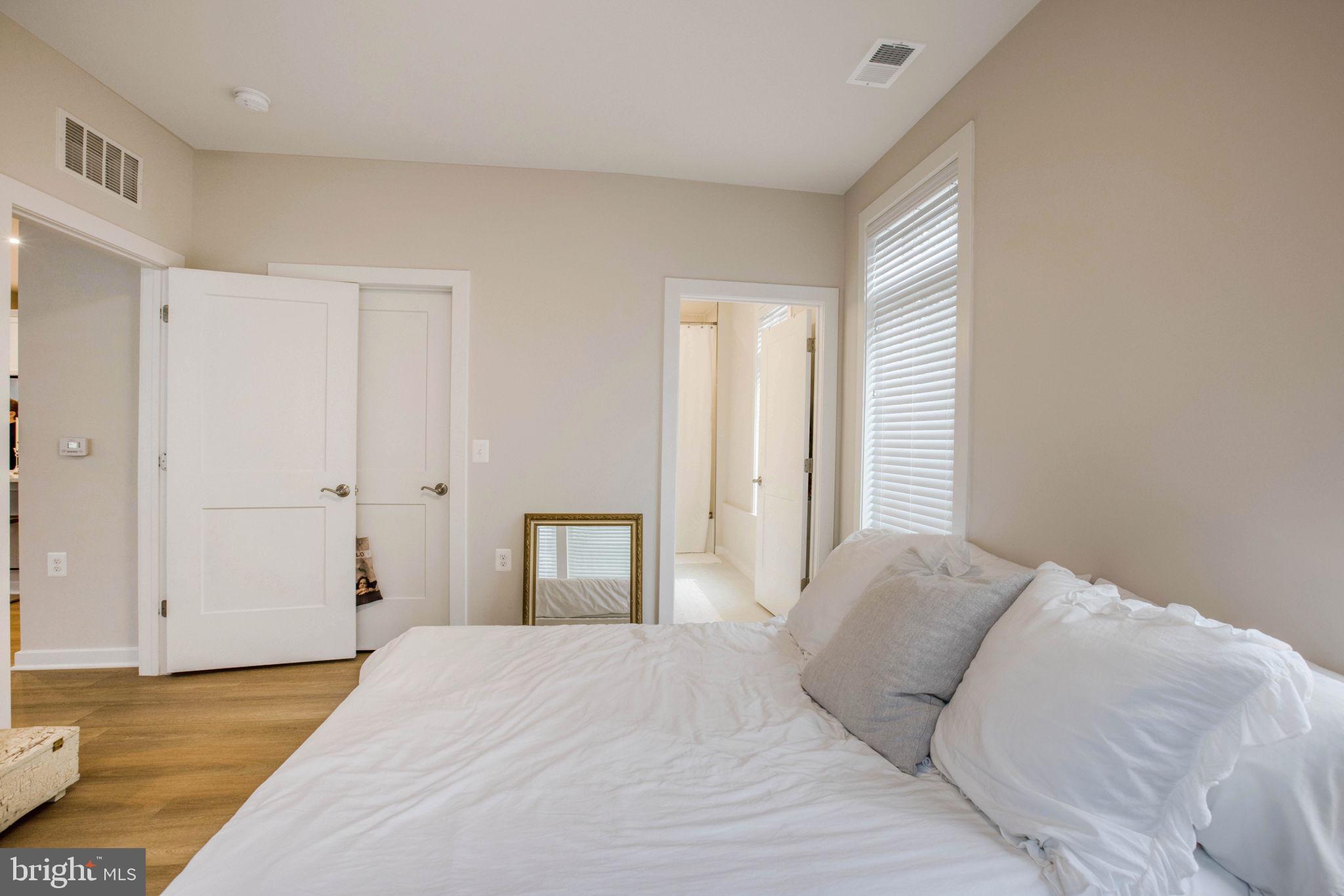 1669 Bandit Loop, Unit 107A Reston, VA 20190 - Photo 16 of 30 a bedroom with a bed and a closet