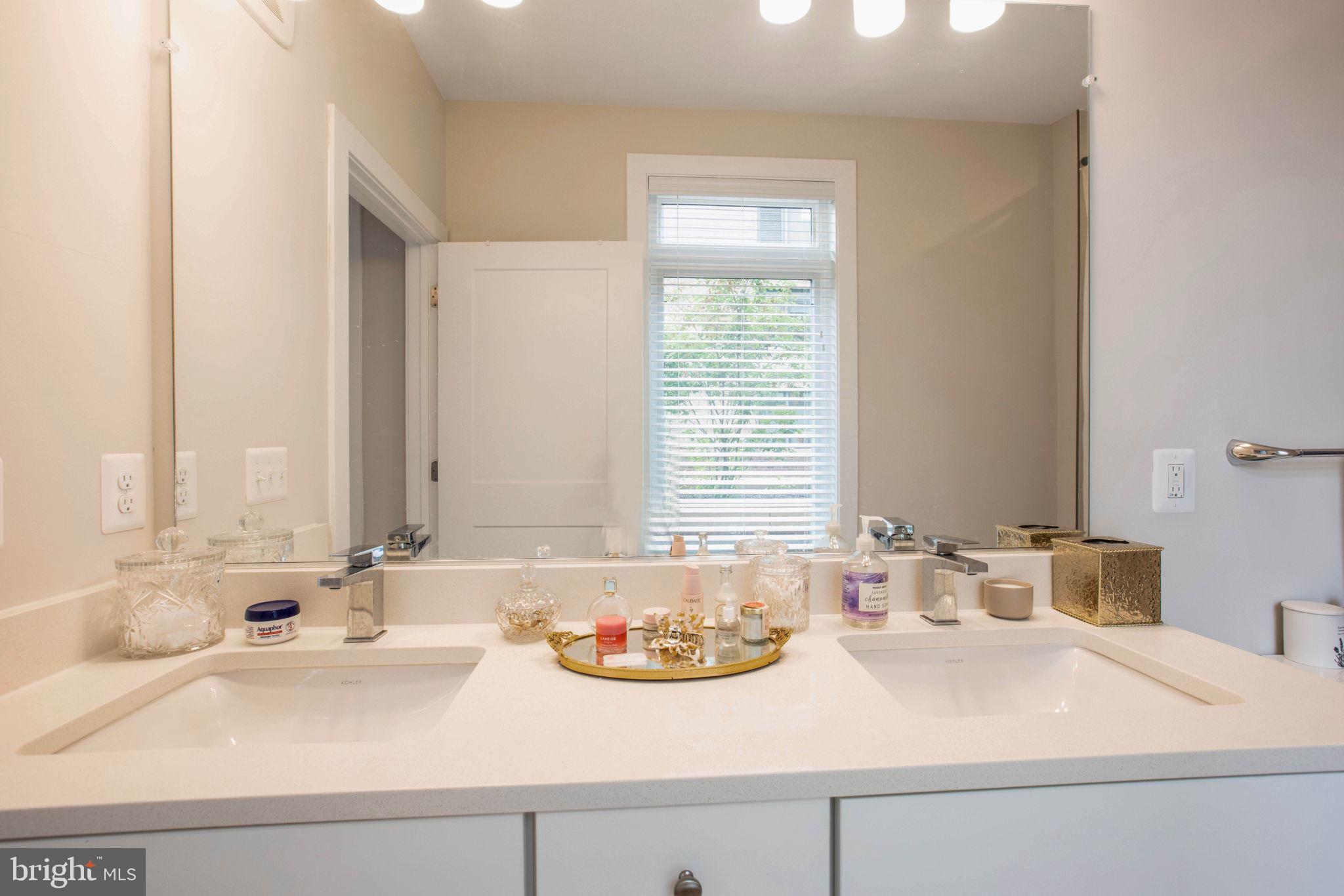 1669 Bandit Loop, Unit 107A Reston, VA 20190 - Photo 19 of 30 a bathroom with a sink and a window