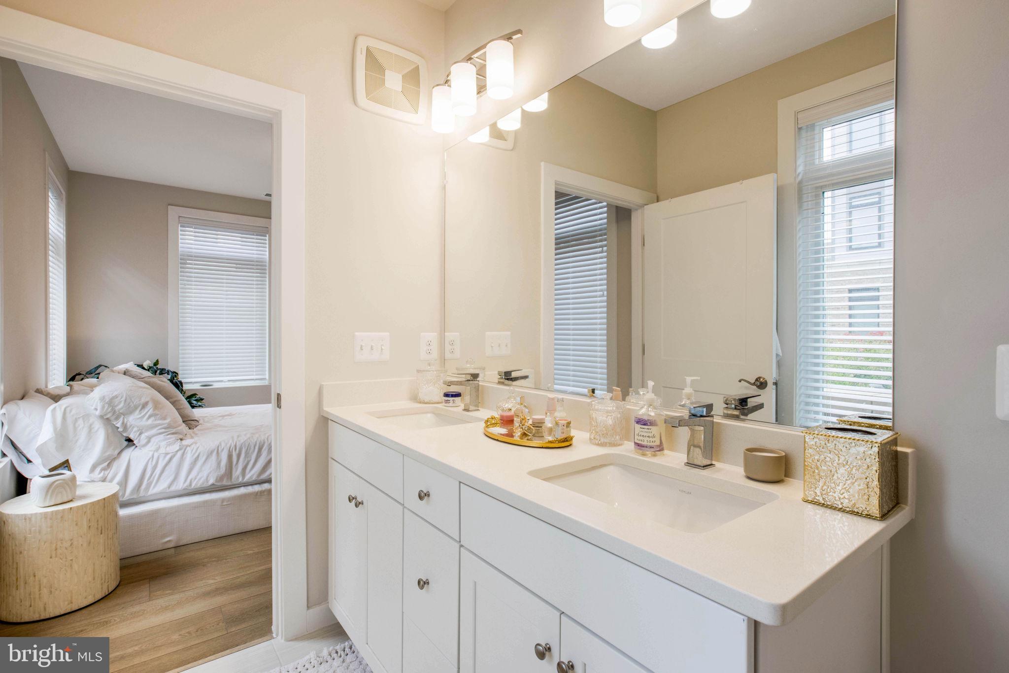1669 Bandit Loop, Unit 107A Reston, VA 20190 - Photo 21 of 30 a bathroom with a double vanity sink and a mirror