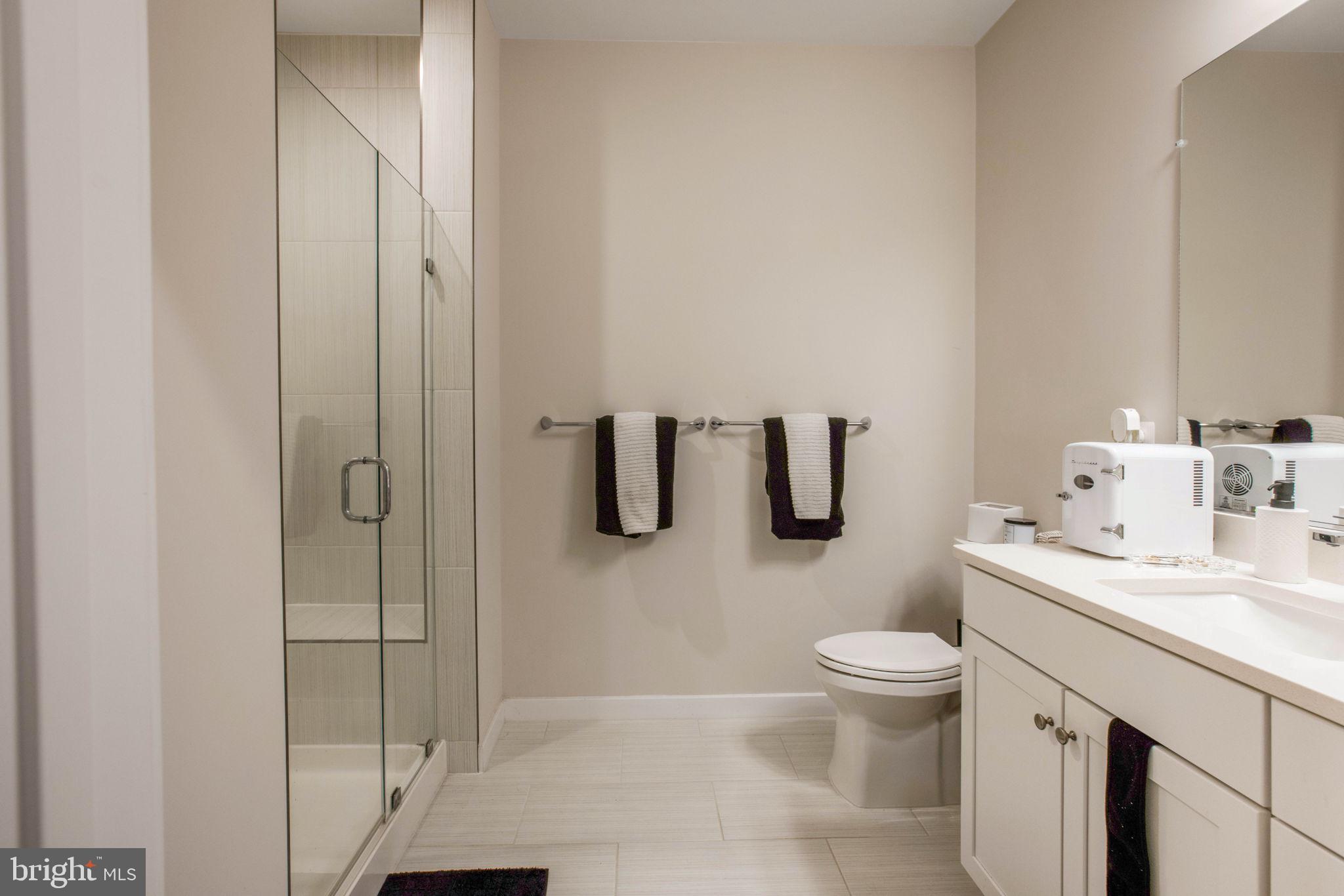 1669 Bandit Loop, Unit 107A Reston, VA 20190 - Photo 23 of 30 a bathroom with a sink toilet and shower