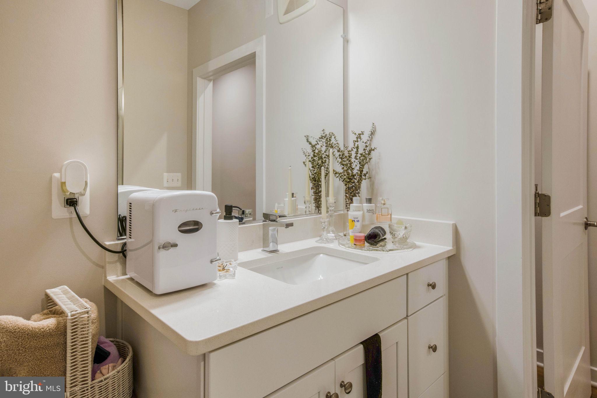 1669 Bandit Loop, Unit 107A Reston, VA 20190 - Photo 24 of 30 a bathroom with a sink and a mirror