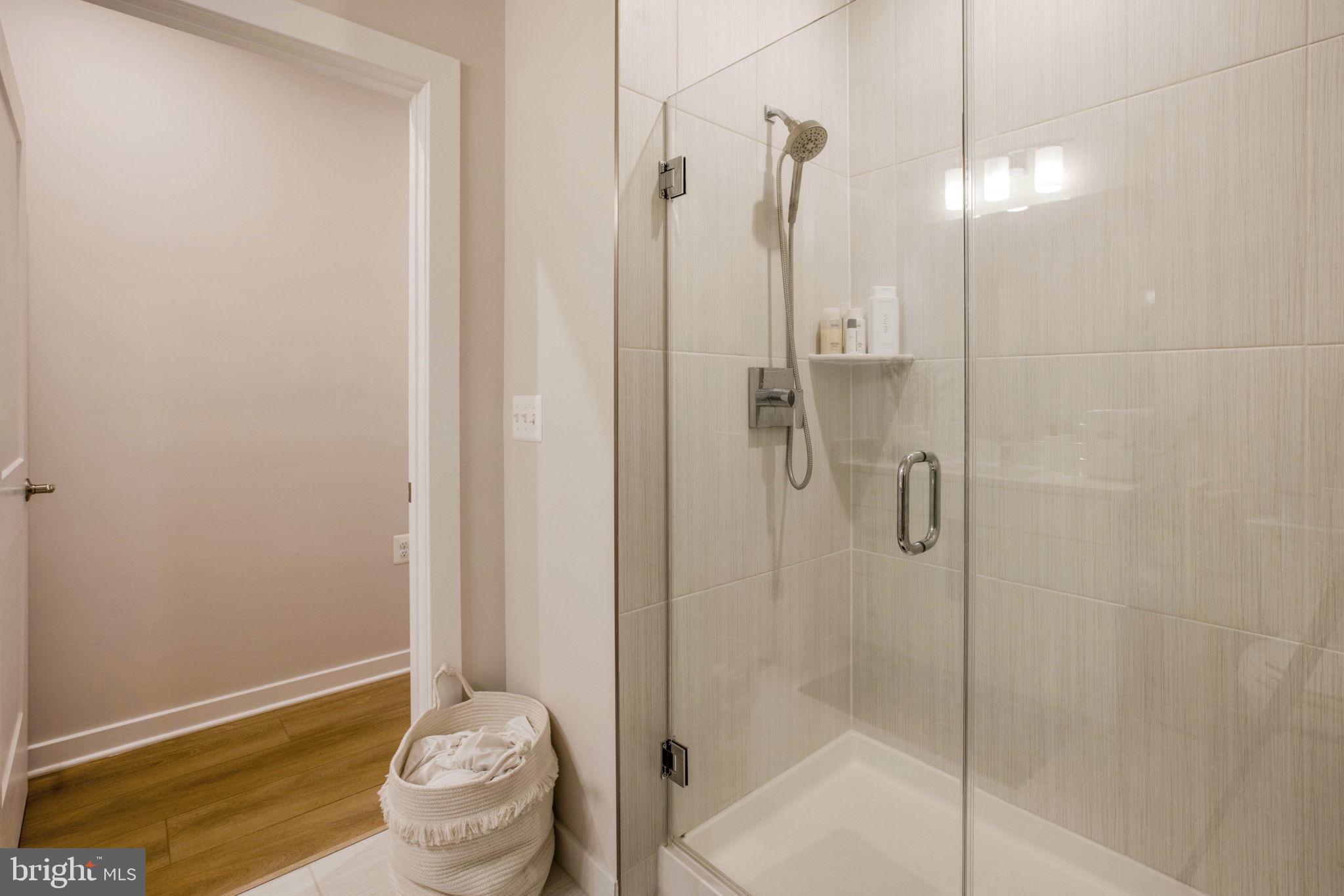 1669 Bandit Loop, Unit 107A Reston, VA 20190 - Photo 25 of 30 a bathroom with a shower
